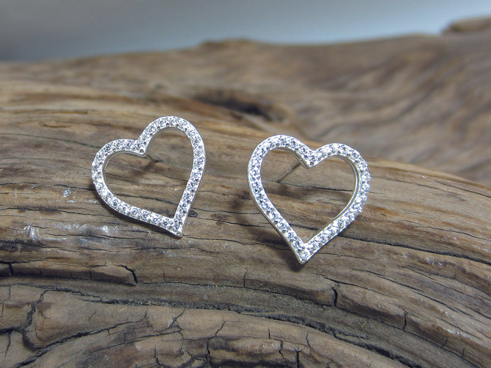 These open heart sterling silver stud earrings are set with cubic zirconias and measure 12mm across. 925 Silver Canterbury