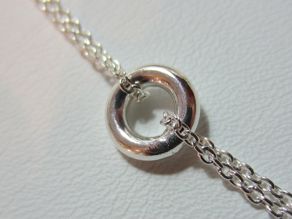 This sterling silver necklace measures 80cm or 32" long. It is made up of 8mm doughnut shpaed beads linked by a double length of fine trace chain.