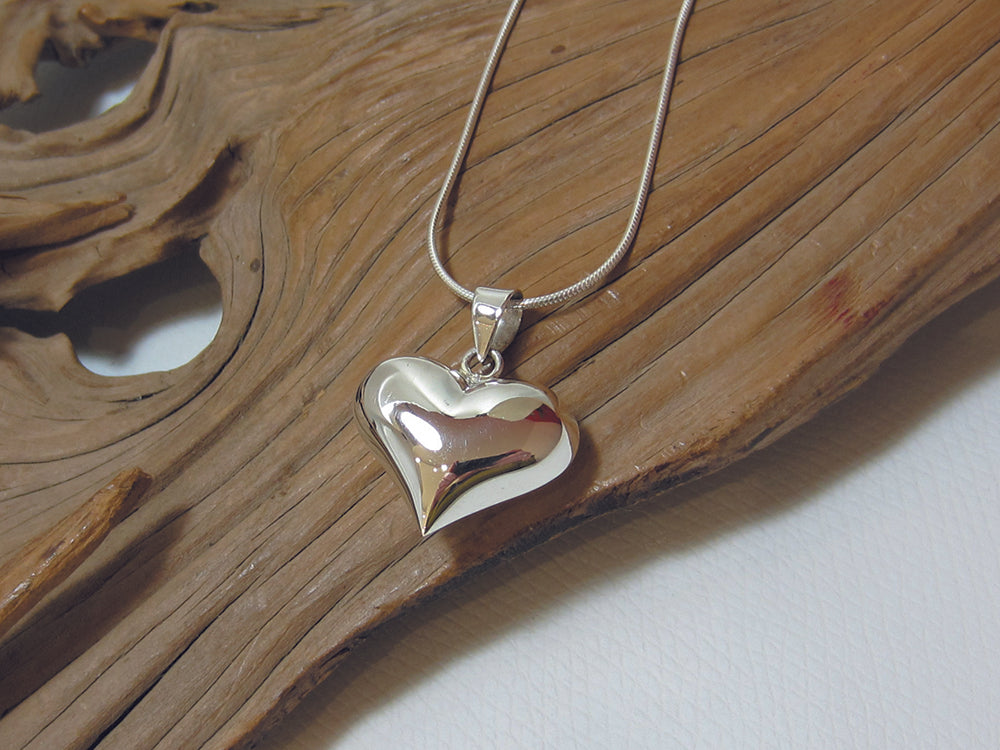 Plain, sterling s ilver puffed heart pendant, it is 24mm wide and 20mm high. It is shown here on a fine snake chain. 925 Silver Canterbury