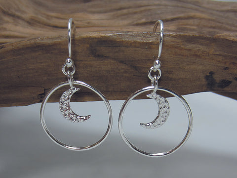 A hammered crescent moon hangs in a 20mm diameter circle all sterling silver. 925 Silver Canterbury