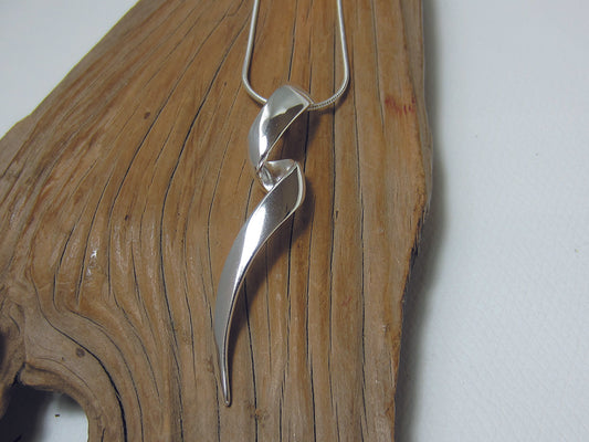 A long, twisty sterling silver pendant which is 53mm long and 12mm wide. It is shown here on a fine snake chain. 925 Canterbury