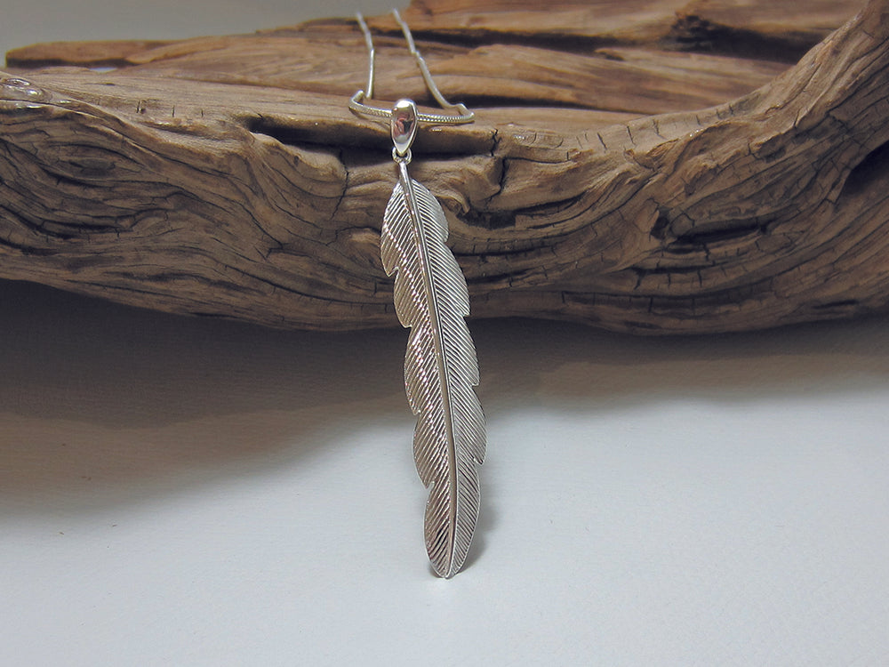 Nicely detailed sterling silver feather pendant. It is 55m long and 10mm wide and is shown on a fine snake chain. 925 Silver Canterbury