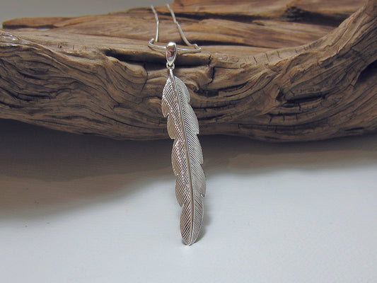 Nicely detailed sterling silver feather pendant. It is 55m long and 10mm wide and is shown on a fine snake chain. 925 Silver Canterbury