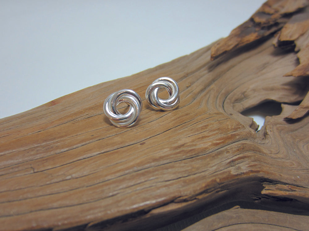 A large, sterling silver flat knot stud measuring 12mm across. 925 Silver Canterbury