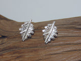 Sterling silver oak leaf studs with a satin finish, they are 12mm long and 8mm wide. 925 Silver Canterbury