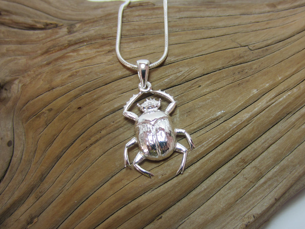 This sterling silver scarab beetle measures 22mm long. It is shown here on a fine snake chain.