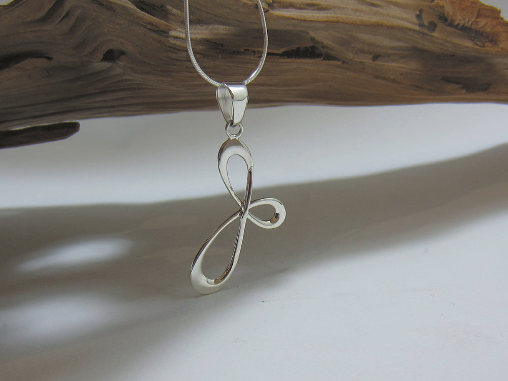 A loopy design this sterling silver pendant is 40mm high and 25mm wide. It is shown here on a fine snake chain.