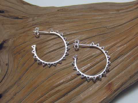 Stylised, sterling silver sun hoop earrings measuring about 23mm across with a butterfly and post fastening. 925 Silver Canterbury