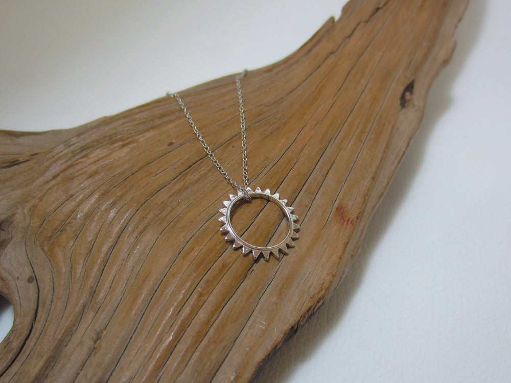 A simple open sun which measures 17mm across and comes on a fine 16" trace chain with a 2" extender so it can be worn longer. Sterling silver