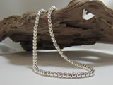 Sterling silver beads strung on a silver chain. The necklace measures 17" or 43 cms long and has a t-bar fastener. It weighs 34 grams so carries a full set of UK Hallmarks. 925 Silver Canterbury