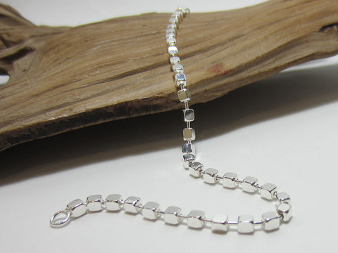 Made up of 3mm cubes this sterling silver bracelet is great for layering or wearing on it's own. It is 19.5cms long.