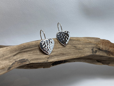 A static, sterling silver drop earring featuring a 24mm hammered heart. 925 Silver Canterbury