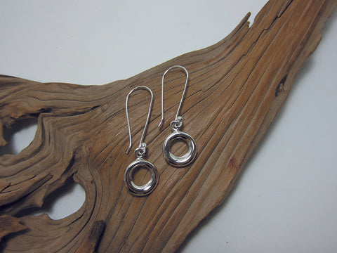 A 15mm diameter 'doughnut' hangs from a longer than usual hook. The hooks are 35mm long so the overall earring measures 52mm long. Sterling silver 925 Canterbury