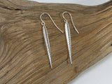 Elegant stylised sterling silver leaf shaped earrings which are 35mm long and 4mm wide. 925 silver Canterbury