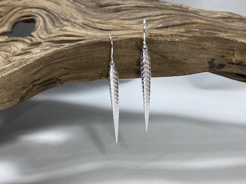 Elegant stylised sterling silver leaf shaped earrings which are 35mm long and 4mm wide. 925 silver Canterbury